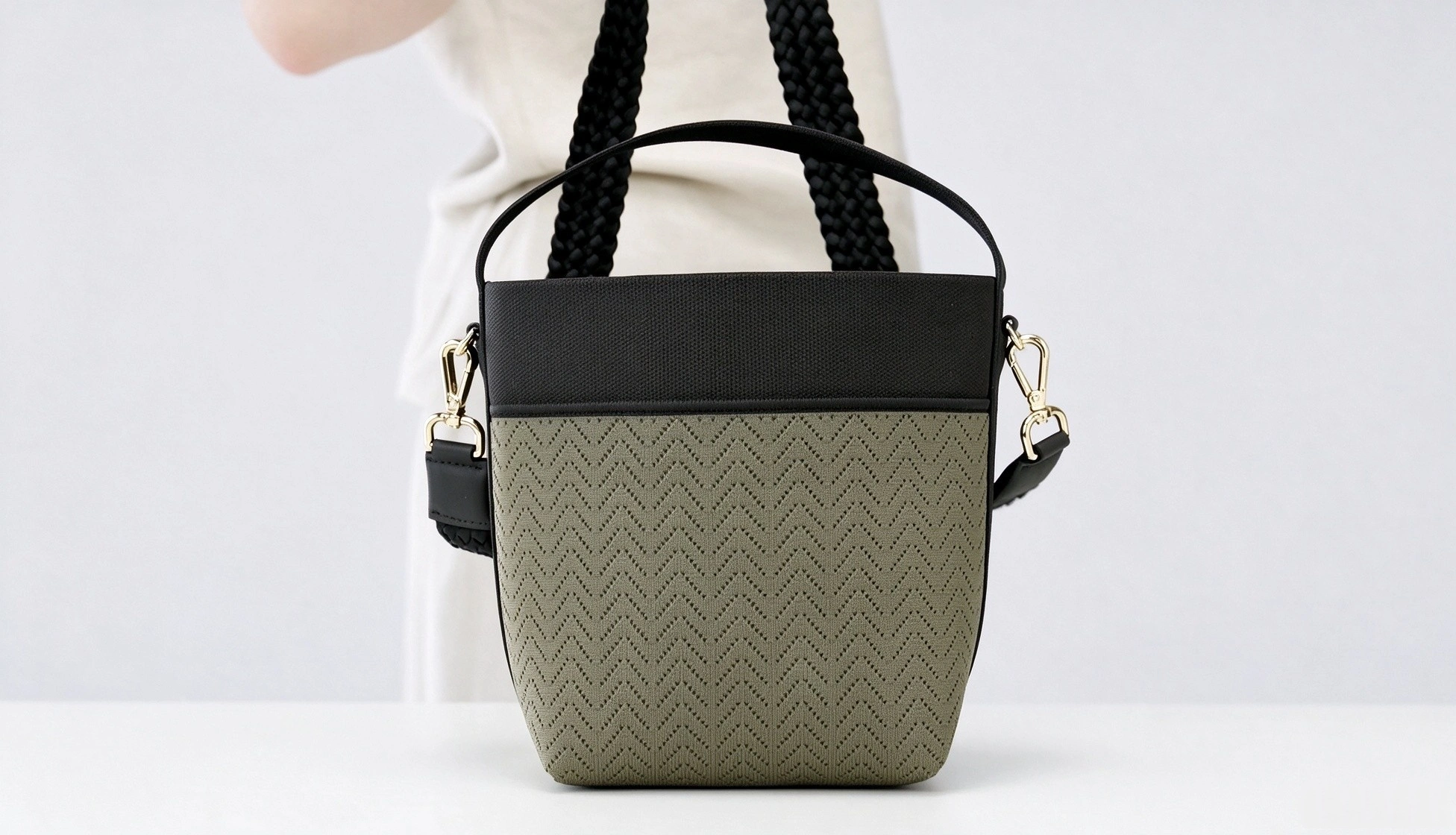 Flyknit trapezoid tote bag in khaki knit pattern with black shoulder strap